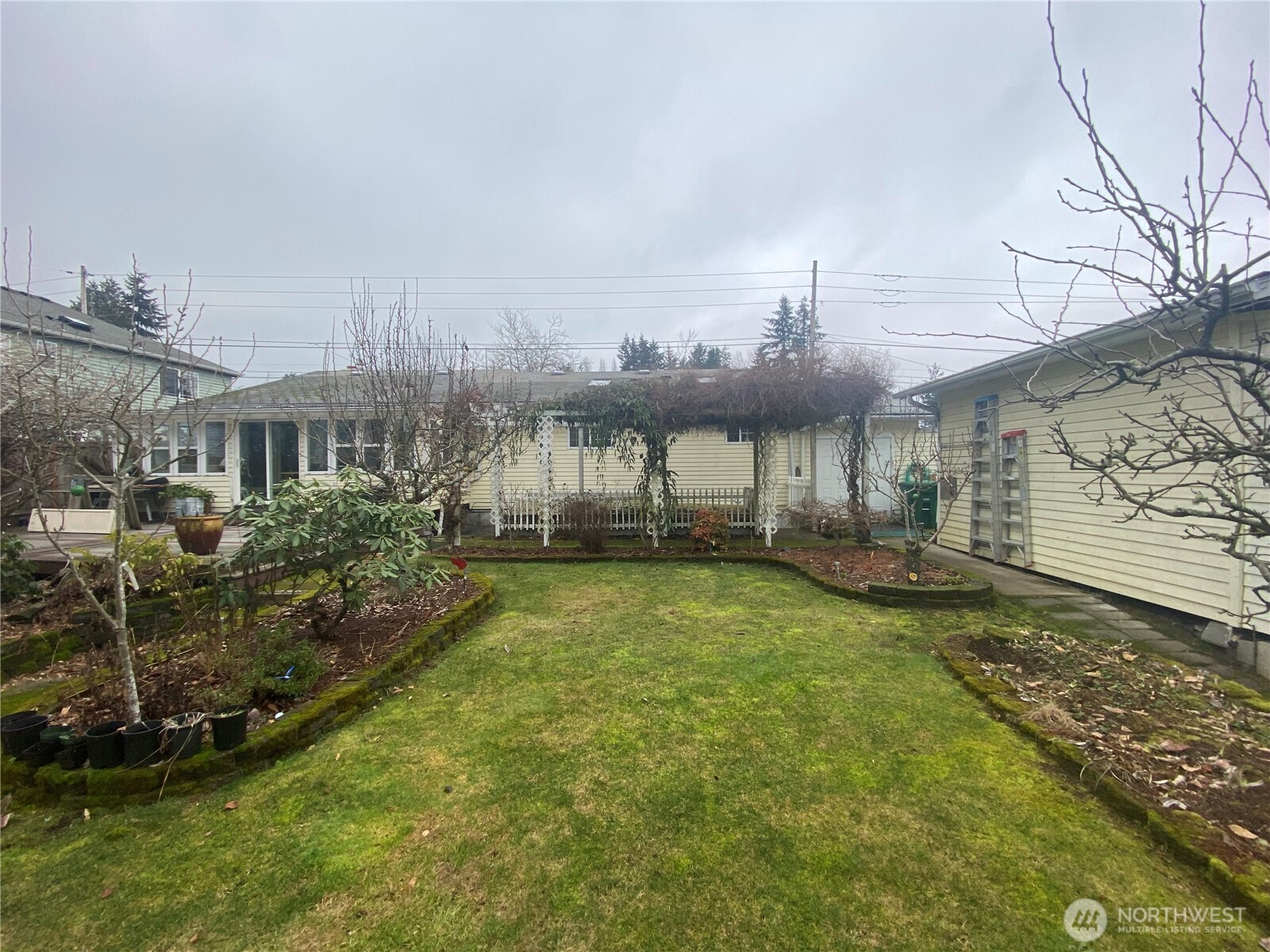 313 Northeast 185th Street Shoreline, WA 98155 - Photo 23 of 24 a view of a house with backyard and a garden