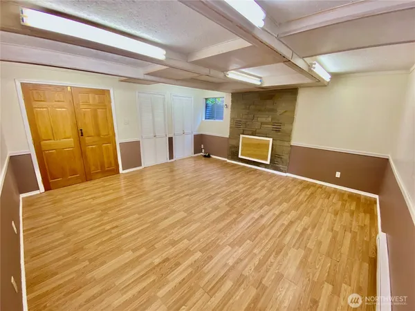 a view of a room with wooden floor