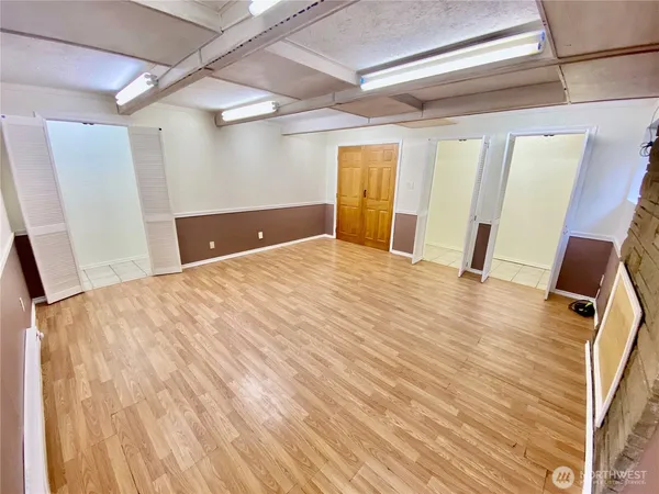 a view of empty room with wooden floor