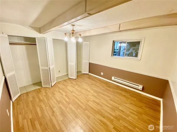 a view of a room with wooden floor
