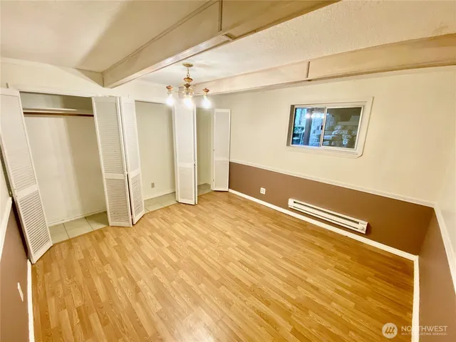 a view of a room with wooden floor