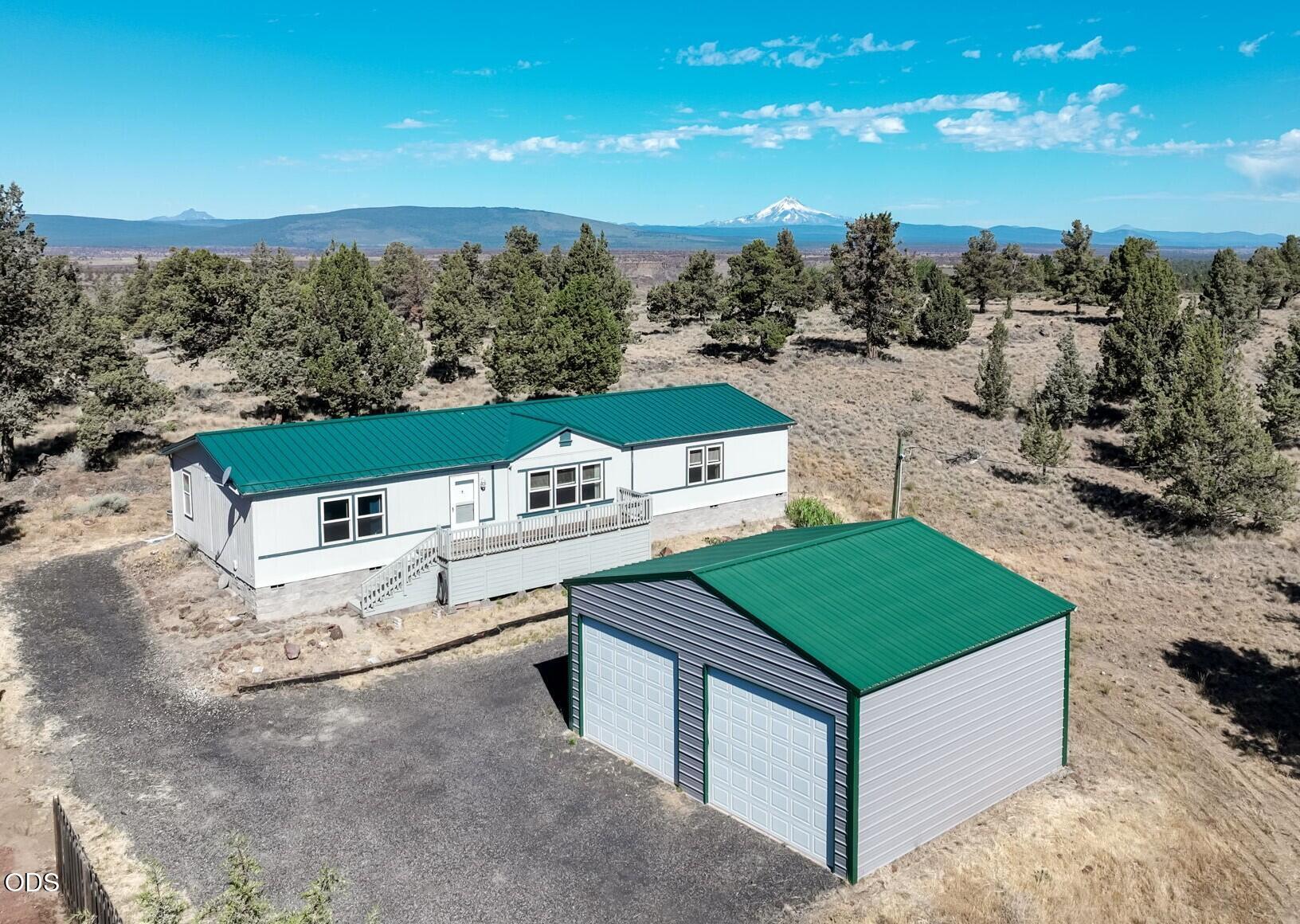 8628 Southwest Crater Loop Road Terrebonne, OR 97760 - Photo 1 of 36 an aerial view of a house with a yard and lake view