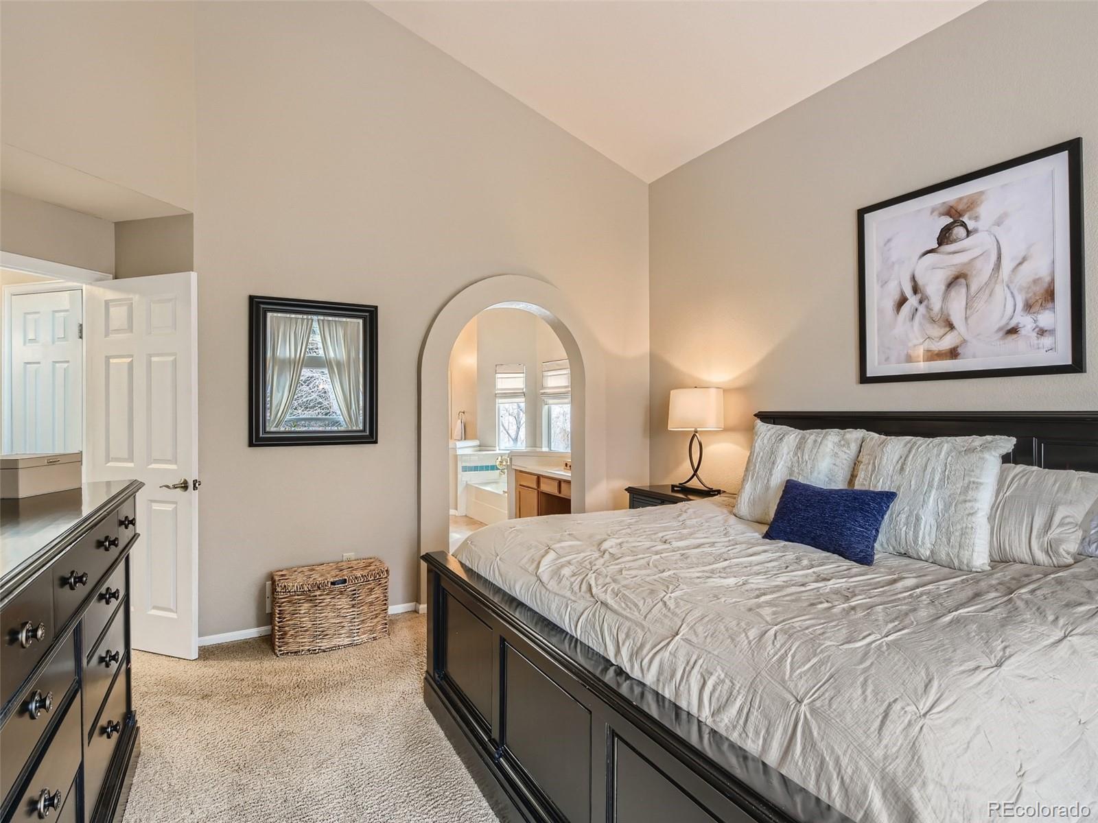 9724 Chanteclair Circle Highlands Ranch, CO 80126 - Photo 17 of 28 a bedroom with a large bed and a painting on the wall