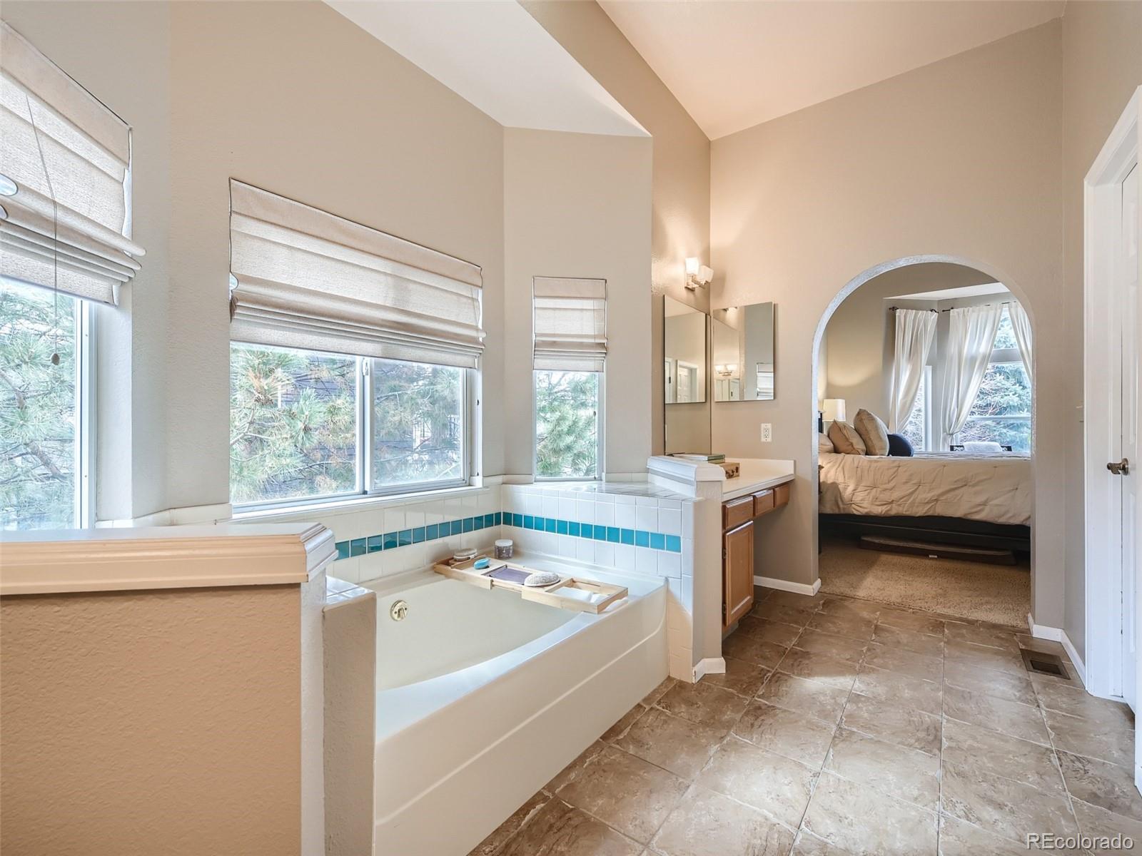 9724 Chanteclair Circle Highlands Ranch, CO 80126 - Photo 18 of 28 a spacious bathroom with a tub sink and mirror