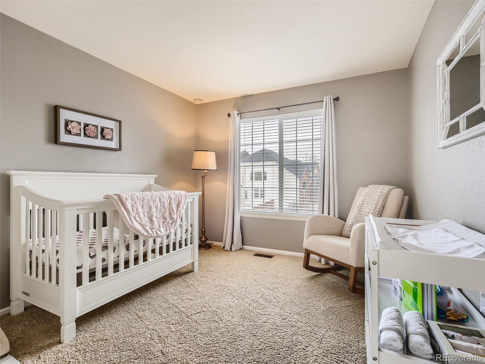 9724 Chanteclair Circle Highlands Ranch, CO 80126 - Photo 20 of 28 a bedroom with a bed and a couch