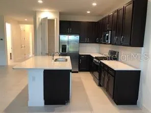 a kitchen with a sink and a wooden cabinets