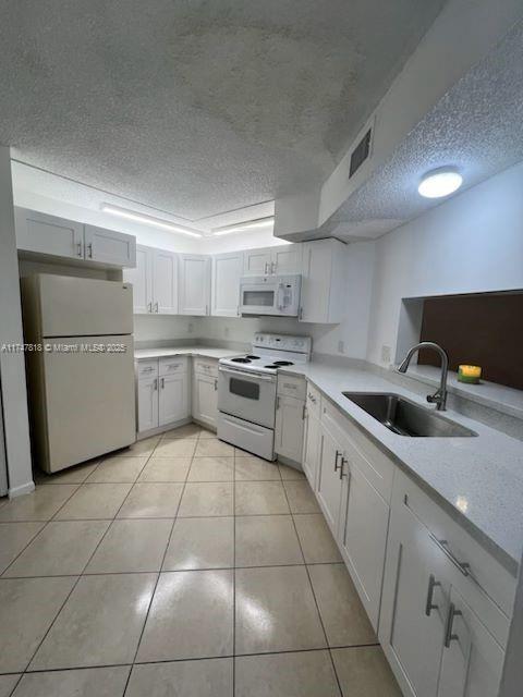 950 Constitution Drive, Unit 950A Homestead, FL 33034 - Photo 2 of 7 a kitchen with cabinets and white stainless steel appliances