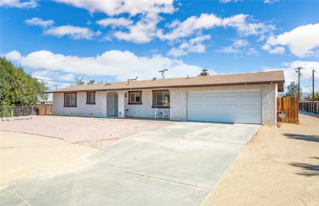 13265 Lakota Road Apple Valley, CA 92308 - Photo 1 of 1 a front view of a house with a yard and garage