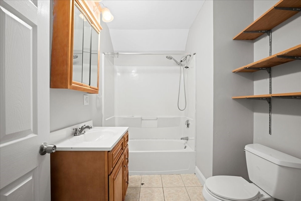 36 Cedar Street, Unit 2A Worcester, MA 01609 - Photo 15 of 25 a bathroom with a sink toilet and shower