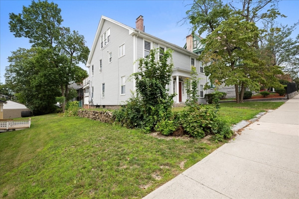 36 Cedar Street, Unit 2A Worcester, MA 01609 - Photo 17 of 25 a view of a white house with a yard and plants