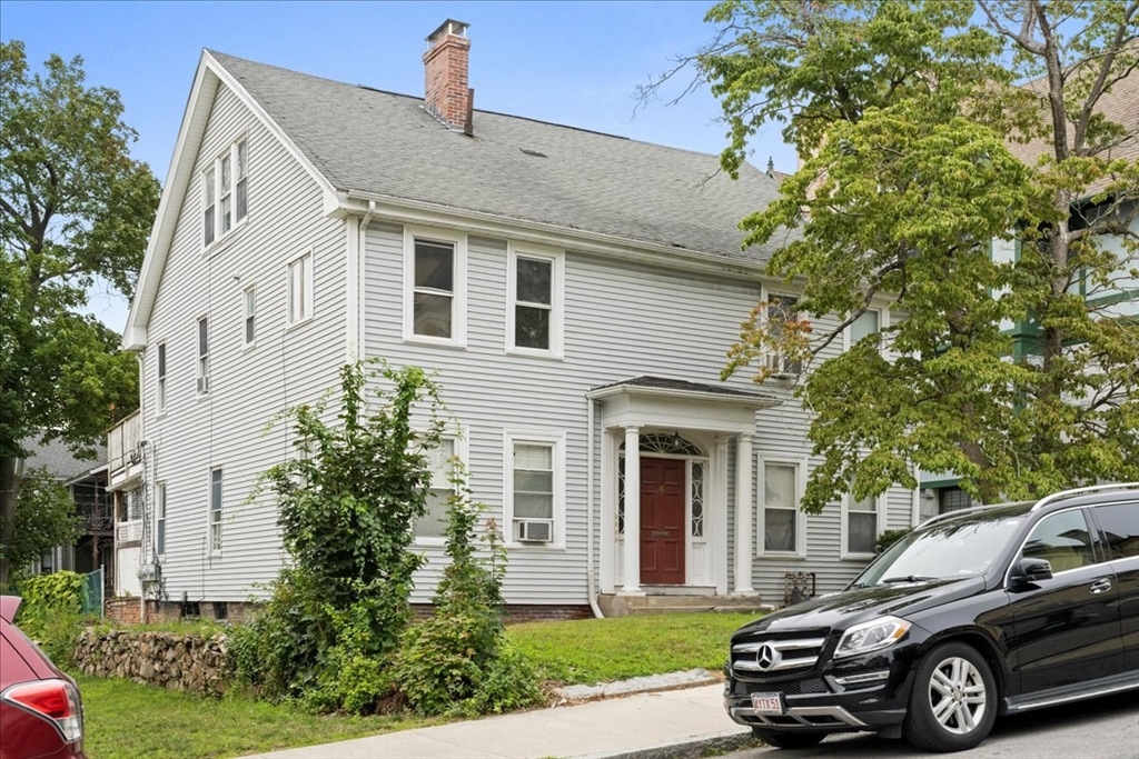 36 Cedar Street, Unit 2A Worcester, MA 01609 - Photo 20 of 25 a car parked in front of a white house