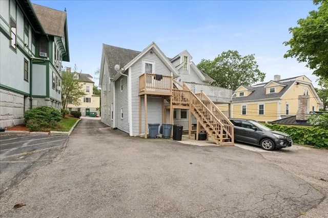 a car parked in front of a white house