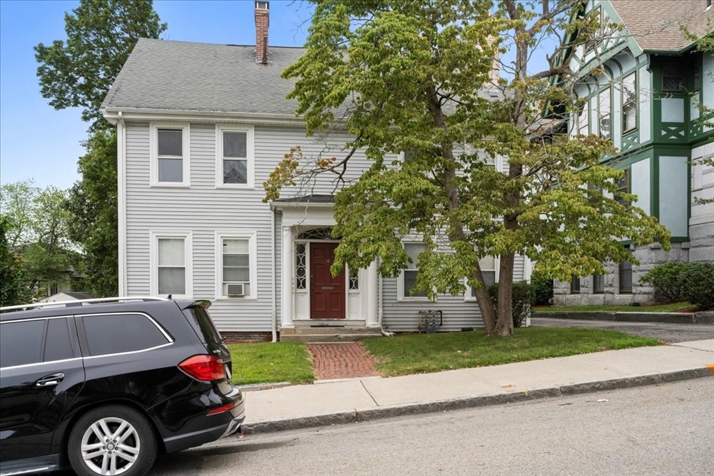 36 Cedar Street, Unit 2A Worcester, MA 01609 - Photo 22 of 25 a car parked in front of a white house