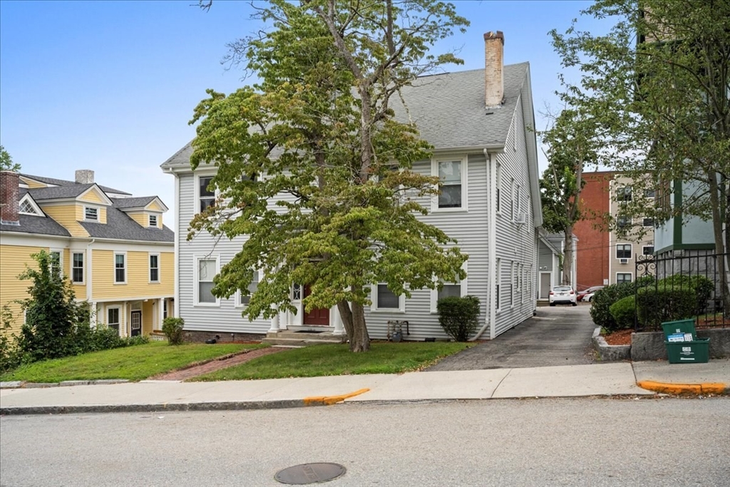 36 Cedar Street, Unit 2A Worcester, MA 01609 - Photo 24 of 25 a front view of a house with a yard and a garage