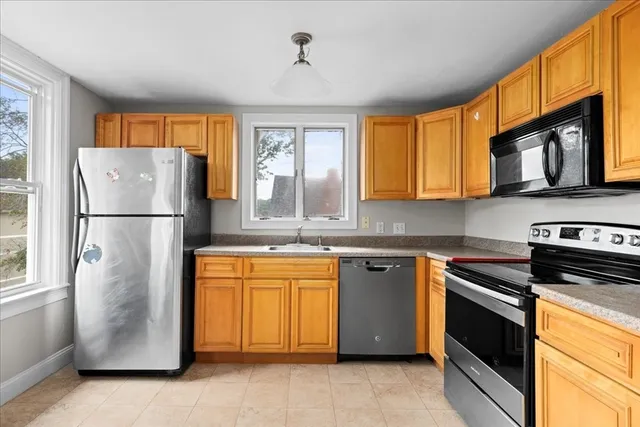 a kitchen with stainless steel appliances granite countertop a refrigerator sink and cabinets