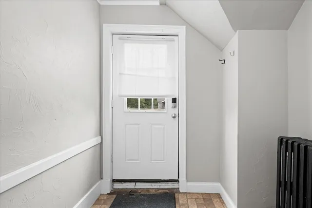 a couple of white house with a trees