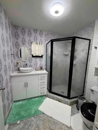 a bathroom with a sink a toilet and a mirror