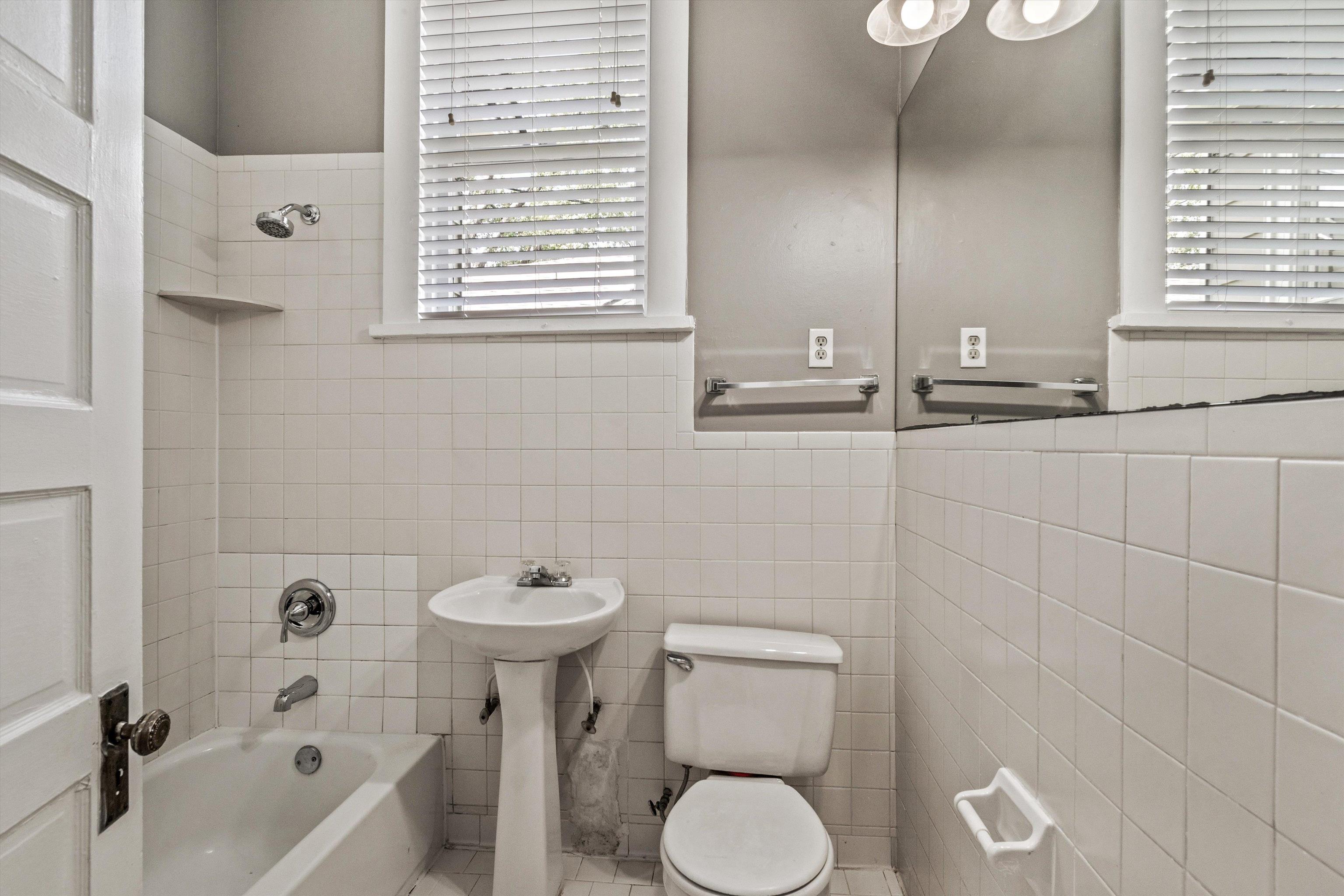1983 Harbert Avenue Memphis, TN 38104 - Photo 12 of 40 a bathroom with a sink a toilet and bathtub