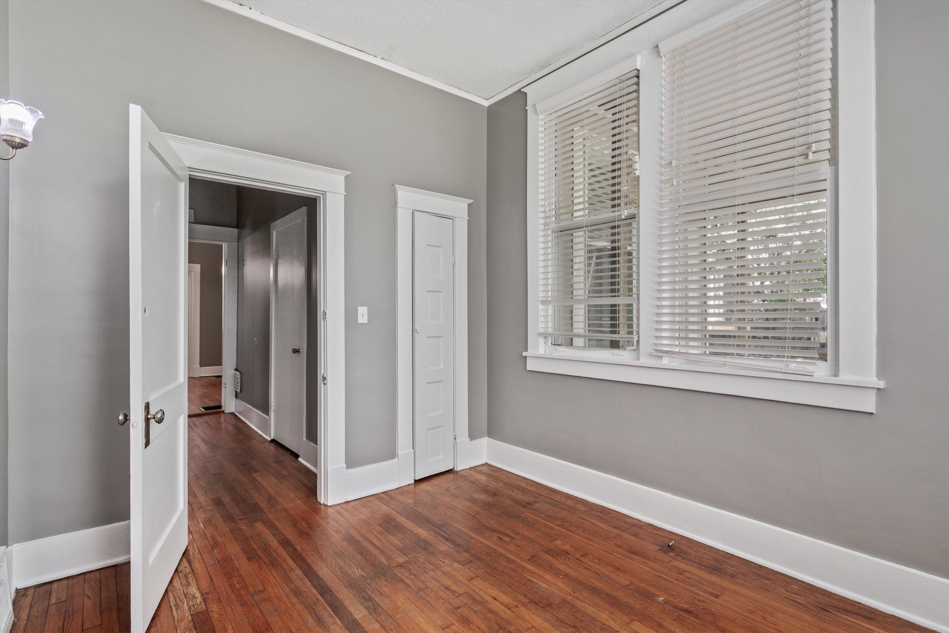 1983 Harbert Avenue Memphis, TN 38104 - Photo 15 of 40 a view of a hallway with wooden floor and a window