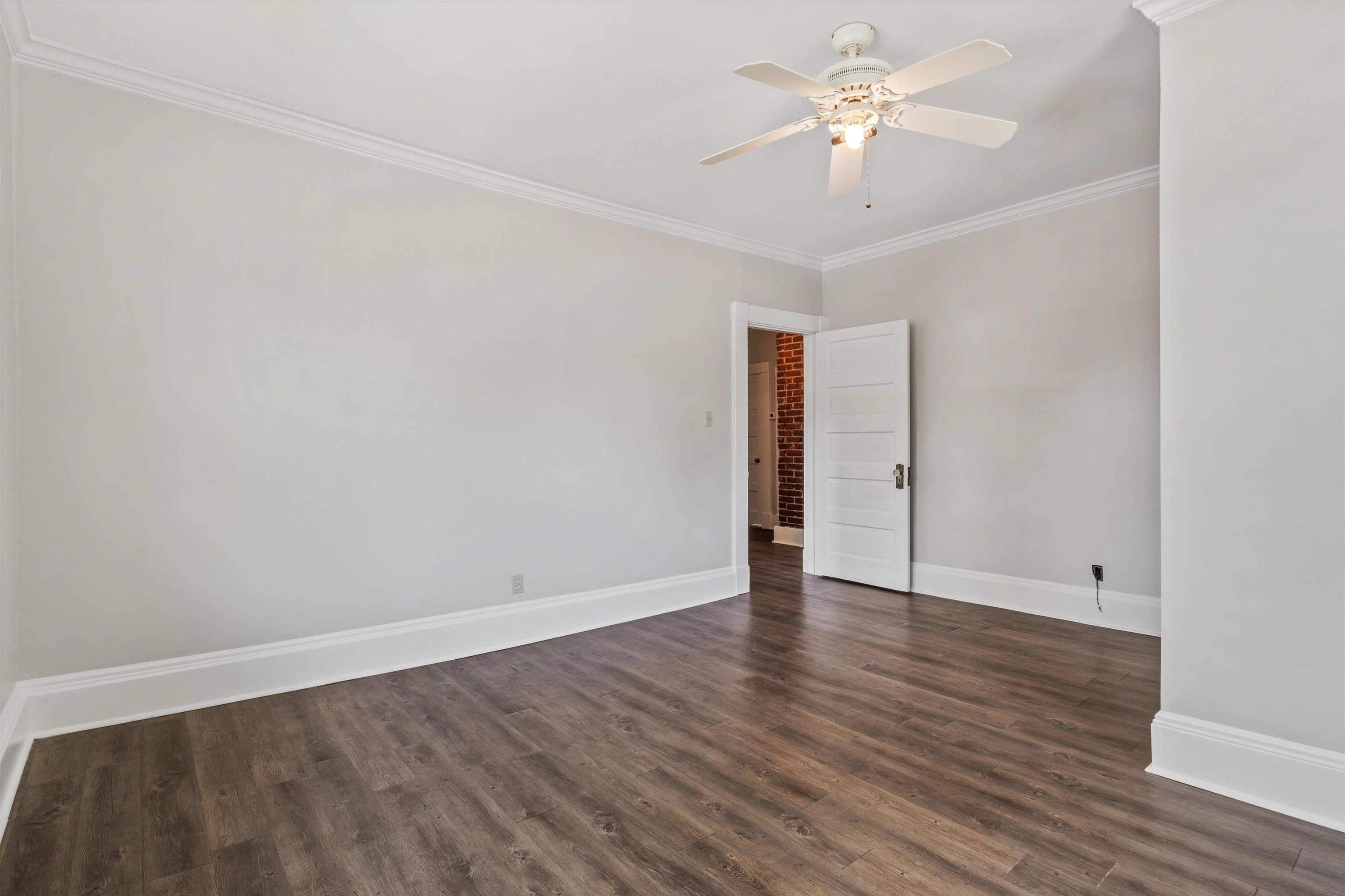 1983 Harbert Avenue Memphis, TN 38104 - Photo 22 of 40 a view of an empty room with wooden floor