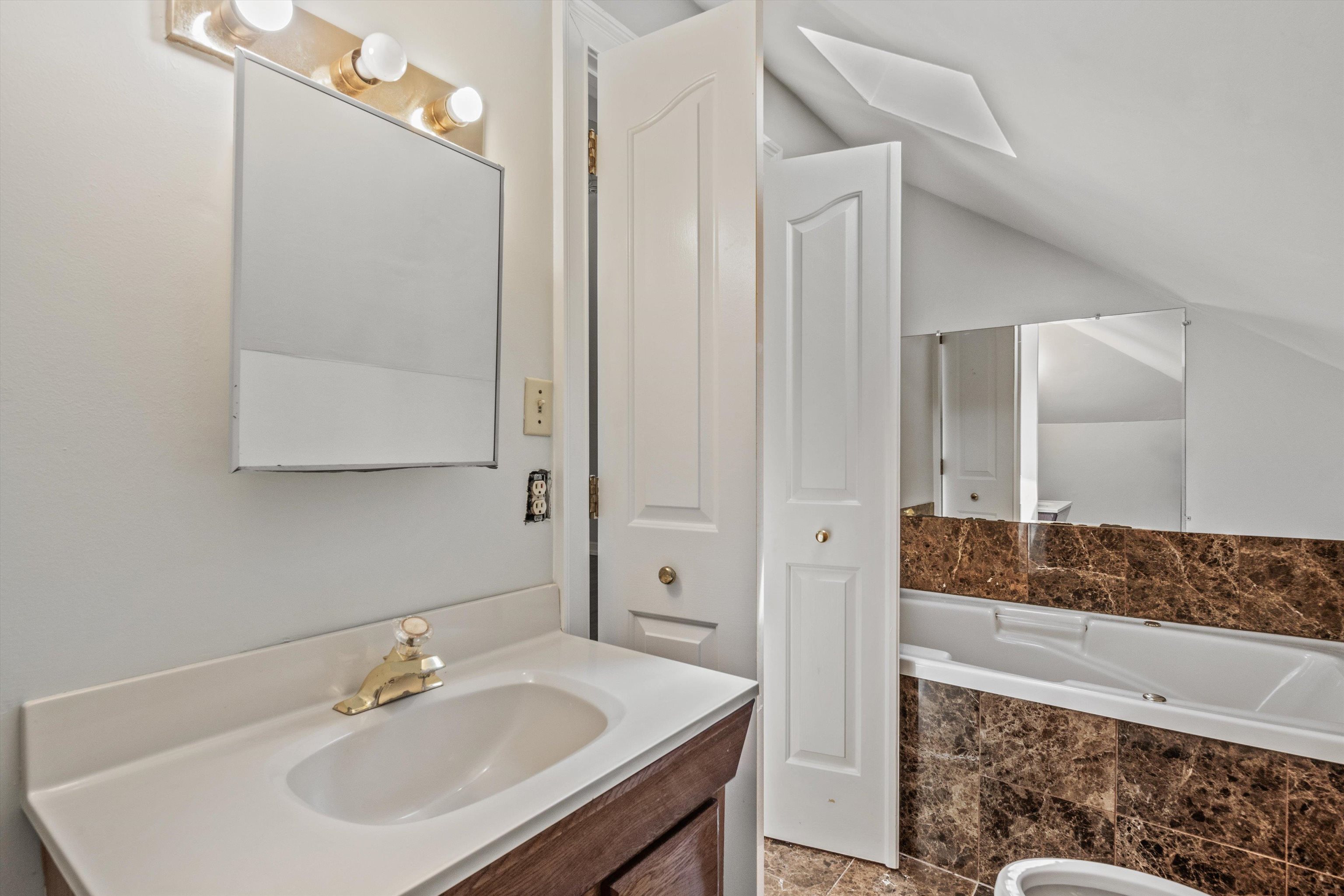 1983 Harbert Avenue Memphis, TN 38104 - Photo 29 of 40 a bathroom with a sink and a mirror