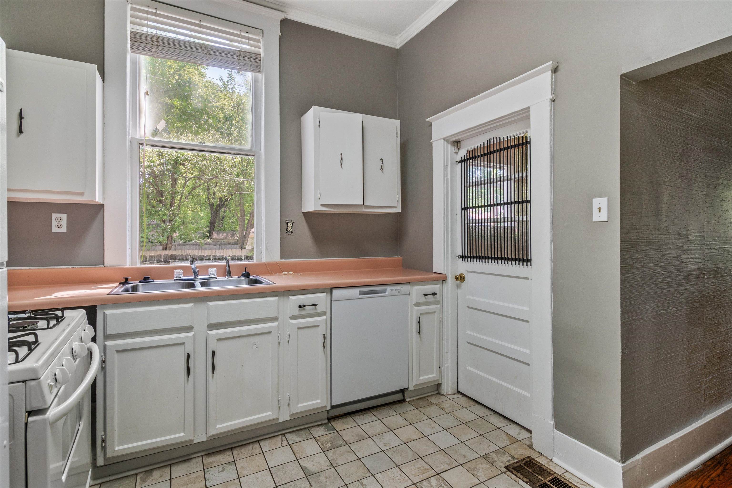 1983 Harbert Avenue Memphis, TN 38104 - Photo 9 of 40 a kitchen with white cabinets and white appliances