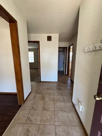 a kitchen with stainless steel appliances granite countertop a stove a sink and a refrigerator with wooden floor
