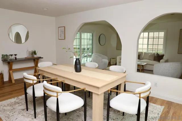a view of a dining room with furniture and a potted plant