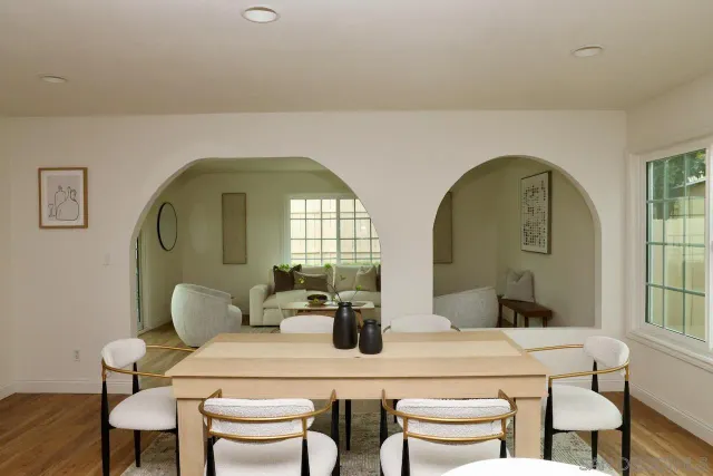 a dining room with furniture and a mirror
