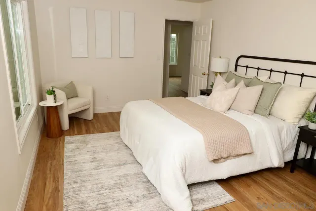 a bed room with a bed and a night stand