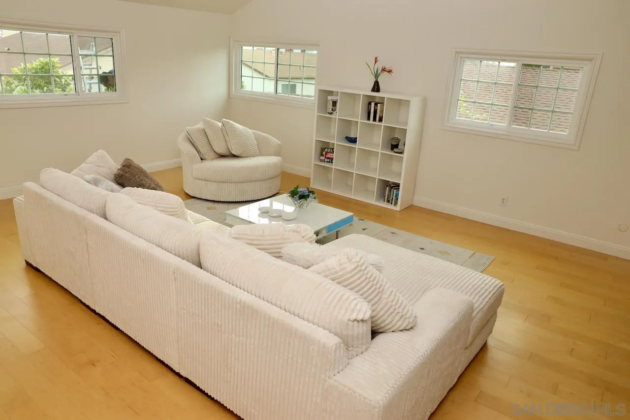 8907 Taurus Place San Diego, CA 92126 - Photo 27 of 40 a living room with a couch and a bookshelf