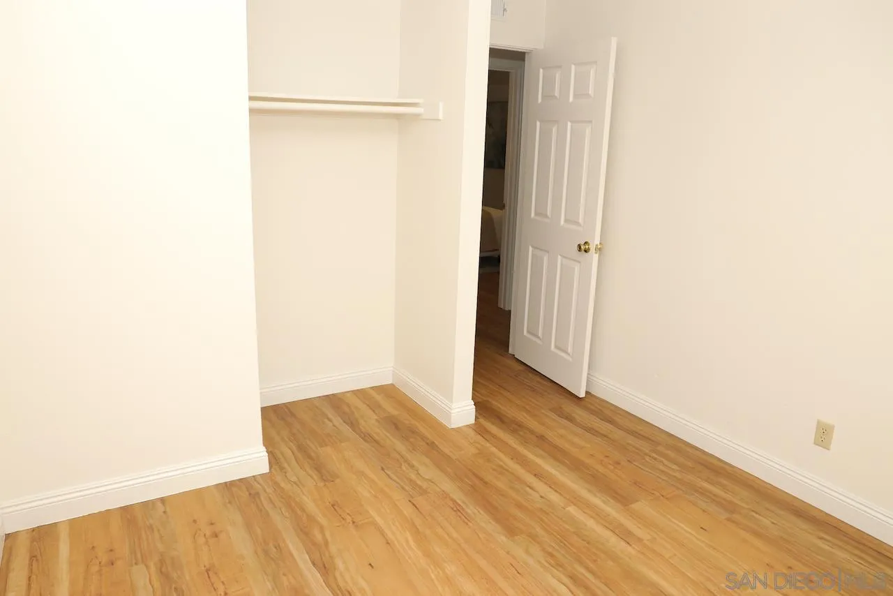 8907 Taurus Place San Diego, CA 92126 - Photo 32 of 40 a view of an empty room with wooden floor