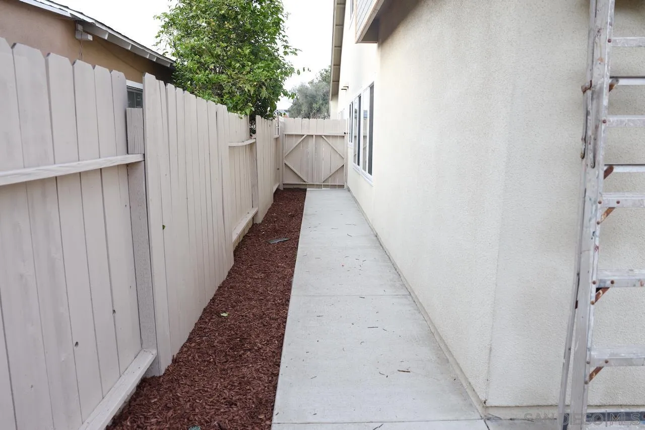 8907 Taurus Place San Diego, CA 92126 - Photo 40 of 40 a view of a pathway with a white house