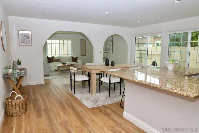 a view of a a dining room with furniture window and wooden floor