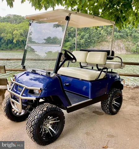 a view of outdoor space with seating area and trees in the background