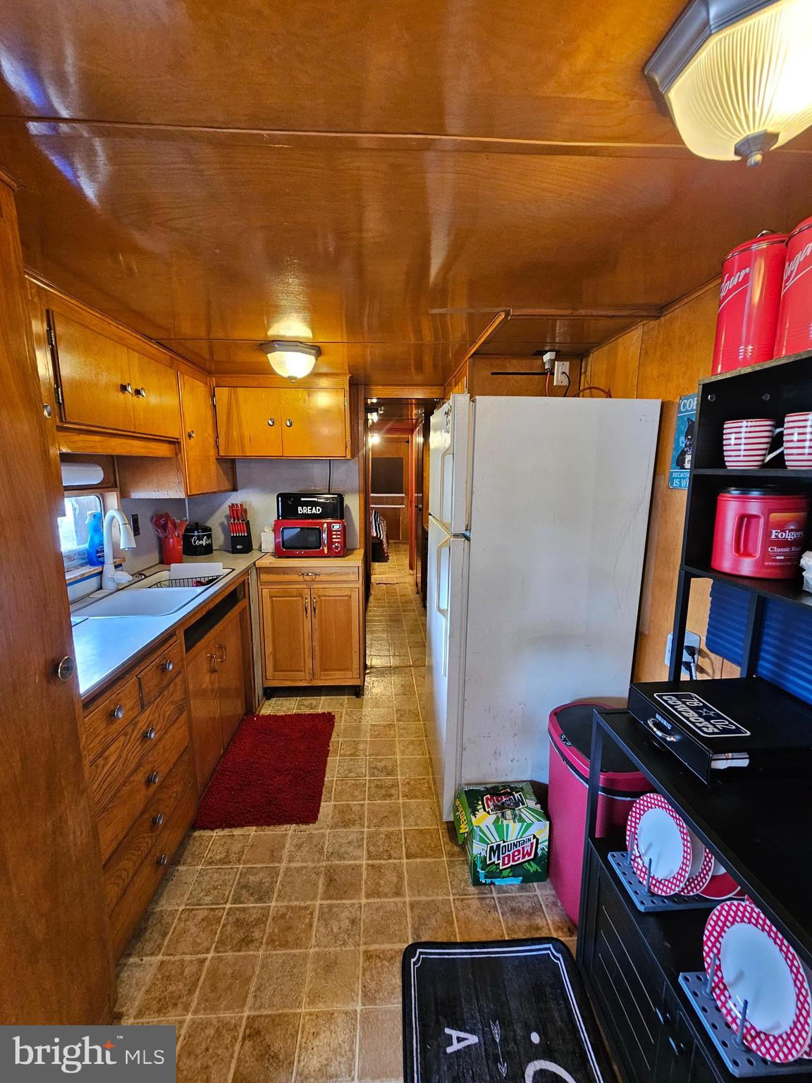 3 Park Boulevard Falling Waters, WV 25419 - Photo 22 of 42 a kitchen with stainless steel appliances granite countertop a sink and wooden cabinets