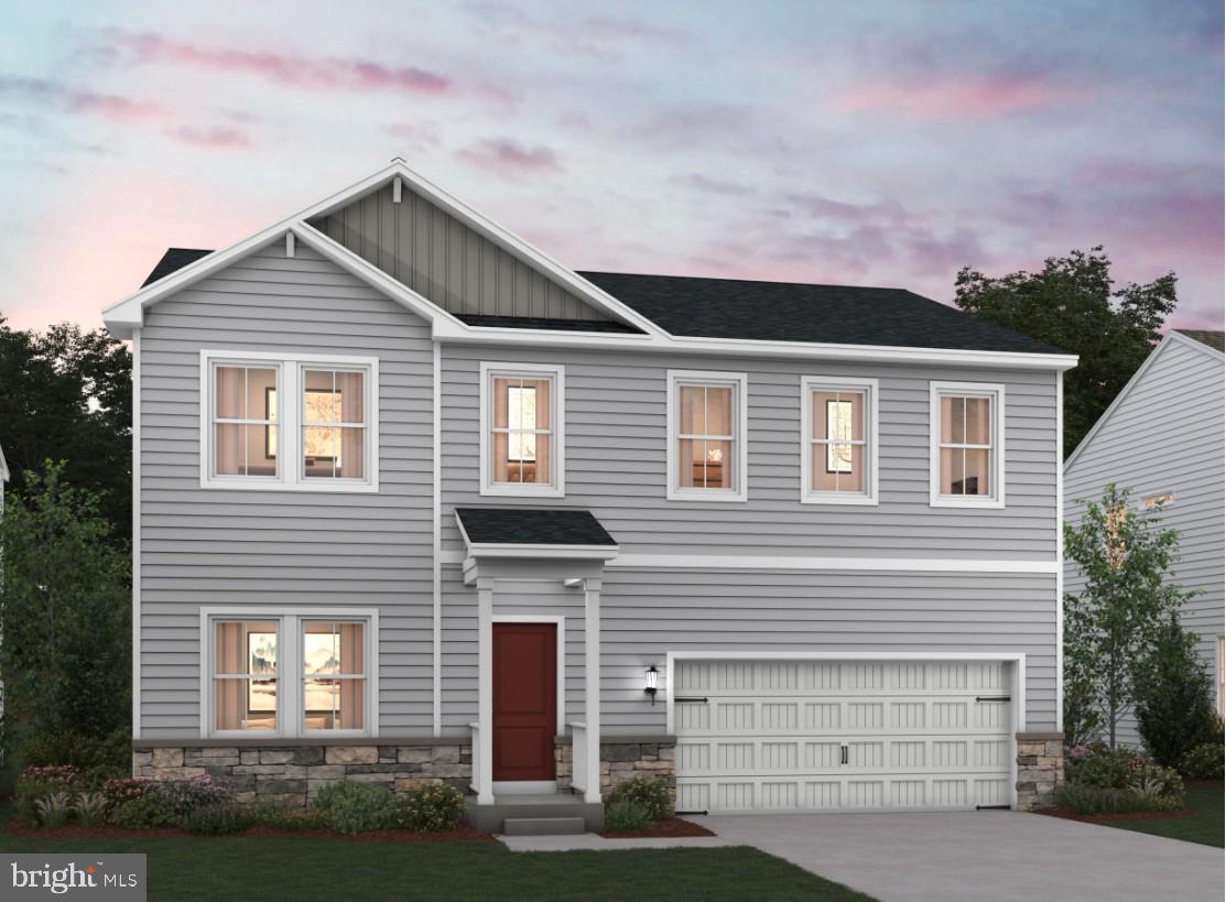 a front view of a house with garage