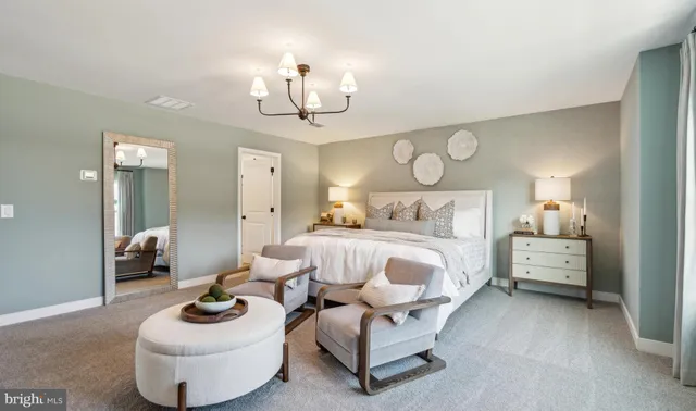 a bedroom with furniture and a chandelier