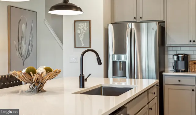a kitchen with a refrigerator and a sink