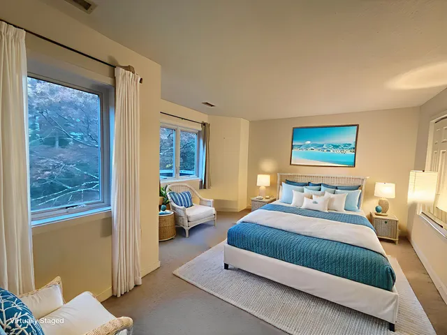 a bedroom with a bed couch and a window