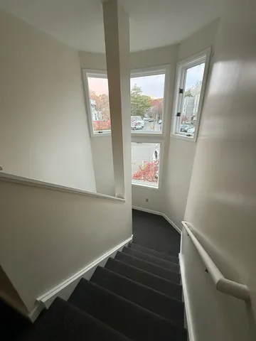 a view of an entryway with wooden floor