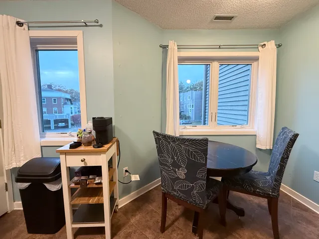 a dining room with furniture and windows