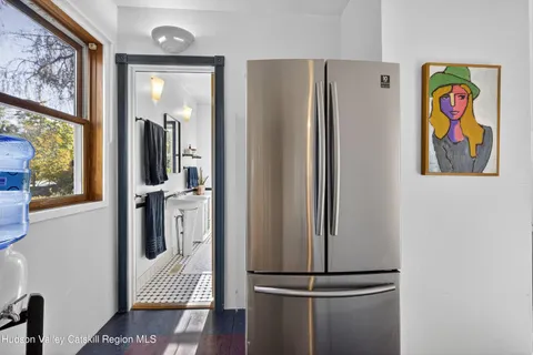 a view of a hallway with wooden floor and a bedroom