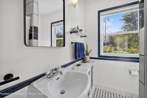 a bathroom with a sink and a large mirror