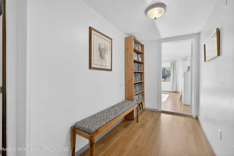 a view of room with window and wooden floor