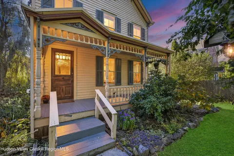 a front view of a house with plants