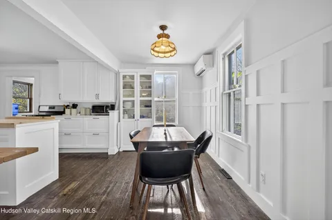 a living room with stainless steel appliances furniture and a table