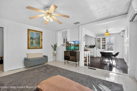 a living room with furniture potted plant and a table