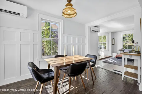 a dining room with furniture and window