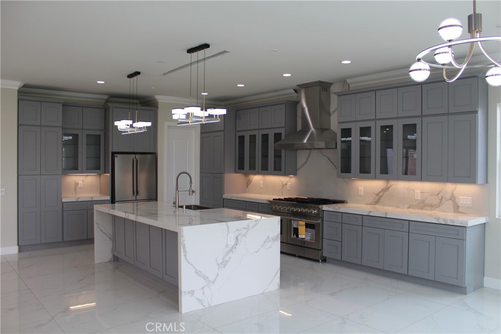 6318 Echo Mountain Rancho Cucamonga, CA 91739 - Photo 23 of 25 a kitchen with stainless steel appliances granite countertop a sink a stove and a refrigerator